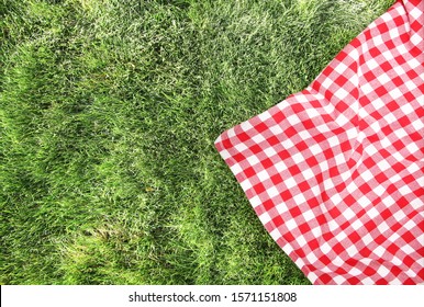 Green Grass Red Checked Picnic Cloth Top View Background.Food Advertisement Design Backdrop.