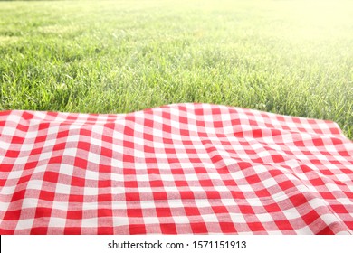 Green Grass Red Checked Picnic Cloth Blanket Top View Background.Food Advertisement Design Backdrop.