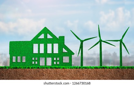 Green Grass In Shape Of Wind Turbines And Building, On Blue Sky And Meadow Soil Cross Section Background, Concept Of ECO, Renewable Energy And Circular Economy.