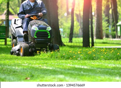 Green grass treeming with lawn mower - Shutterstock ID 1394576669