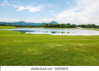 Green Grass Yard With Lake, Thailand.