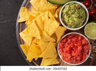 Green Guacamole with nachos and avocado on stone background - Powered by Shutterstock