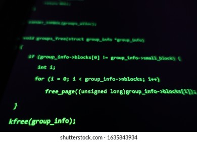 Green hacking code text on dark black blurred background hacker