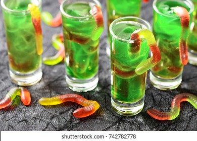 green Halloween jello shots with gummy worms