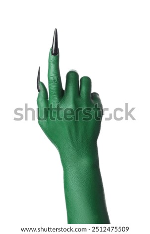 Green hand of witch pointing at something on white background. Halloween celebration
