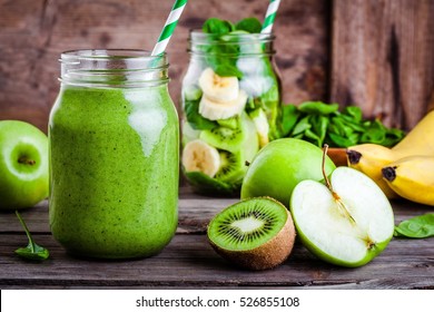 Green healthy  smoothie in  glass jar: banana, kiwi, spinach, green apple on rustic background - Powered by Shutterstock