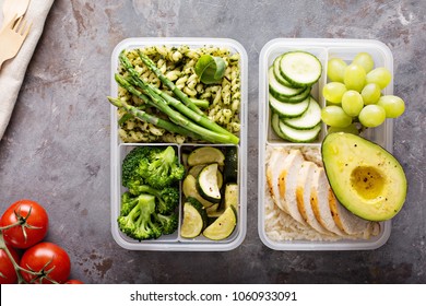 Green and healthymeal prep containers with chicken and pasta with green pesto sauce and vegetables - Powered by Shutterstock