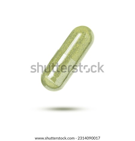Green herbal capsule levitate isolated on white background with clipping path.