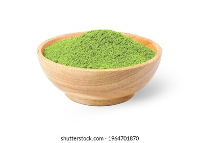 Green herbal powder in wooden bowl isolated on white background. Clipping path.