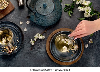 Green Herbal Tea With Cups And Teapot On Gray Backround. Top View