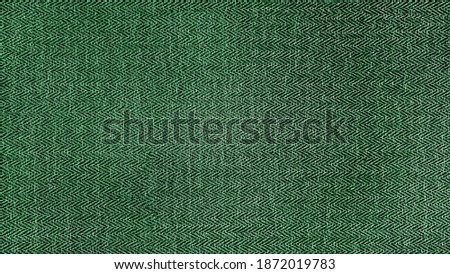 green herringbone tweed pattern, wool fabric background texture. interior material background. illumination background.