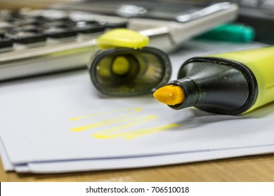 Green Highlighter On White Paper Next To Calculator