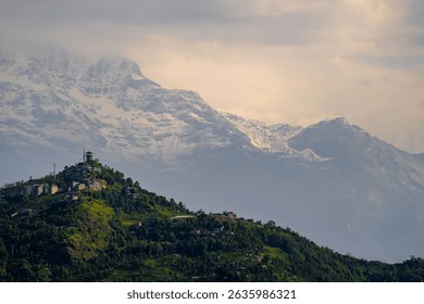 The green hill and Annapurna mountain range in the background. Pokhara, Nepal.