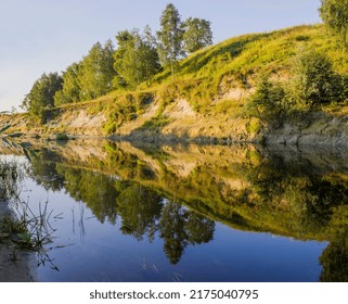 green hill on the bank of the river on a summer day in Ukraine in Europe