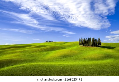 Green hills under a blue sky with clouds. Green hills landscape. Summer green hills panorama. Green hill valley landscape