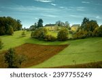 Green hilly landscape with blue sky background