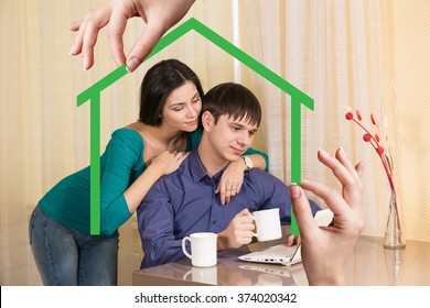 Green House Shape With Young Family Inside