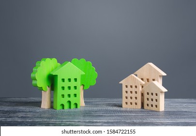 Green House With Trees And Ordinary Residential Buildings. Energy Efficiency, Profitability In Maintenance. Zero Carbon Emissions, Conservation, Energy Saving. Developed Infrastructure, Park Areas.