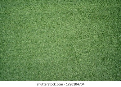 Green imitation grass material is for carpet, flooring, wall and sports stadiums.  Good for indoor and outdoor usage.  Durability, decoration, objects, background and textures. - Shutterstock ID 1928184734