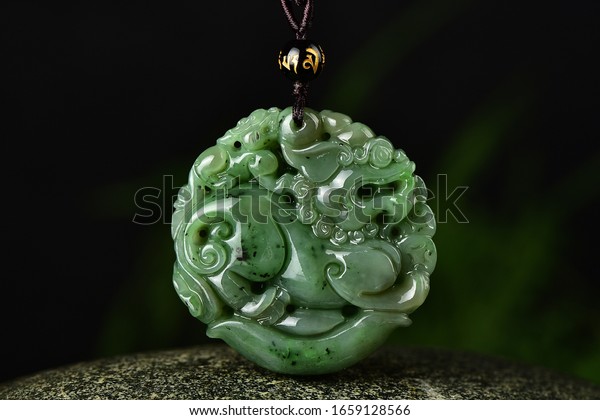 Green jade pendant\
in the shape of a dragon