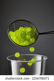 green jelly bubble tea balls and plastic cup on dark black background - Shutterstock ID 2256700371