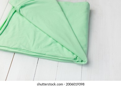 Green Jersey Fabric. Cut For Clothes On A White Background