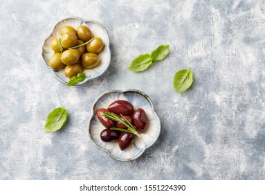 Green And Kalamata Olives On Bright Wooden Background. Top View. Copy Space. 