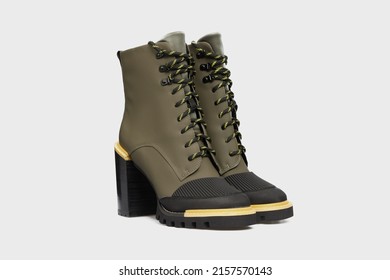 Green Khaki Female Sports rain fashion boots shoes with high heels and laces isolated on white background. With rubber boot toe. Women's unusual leather Footwear, wellies, side view, banner