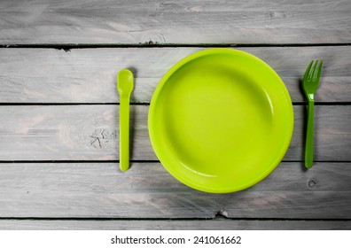 Green Kids Plate On Wooden Background