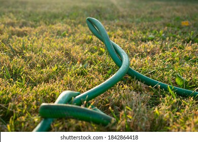 a green kinked garden hose