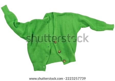 Green knitted sweater with buttons, laid out as if levitating on a white background, isolate