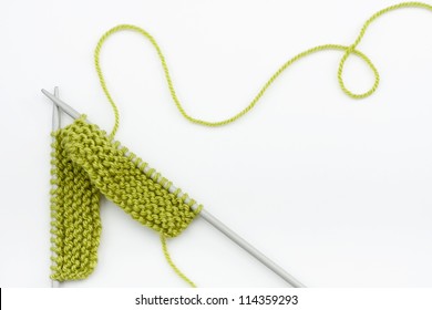 Green Knitting Wool And Knitting Needles