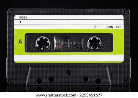 Green labeled retro vintage compact cassette A - side on black background