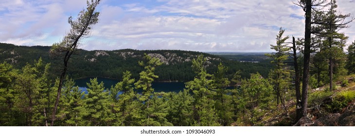 Green Lake Behind Trees, Taken Somewhere Along The La Cloche Trail In The Killarney National Park, Ontario, Canada