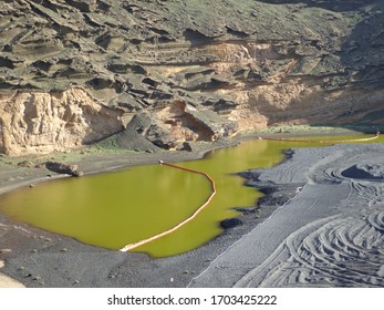 Green lake between sharp rocks