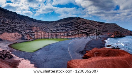 Green lake El Golfo on Lanzarote in Canary islands. There is black beach and blueocean. 