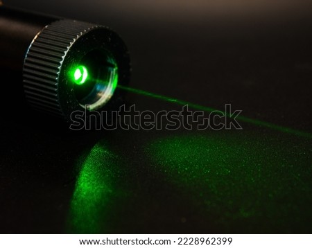 Green laser pointer. High power laser pointer use of lighting in the sky