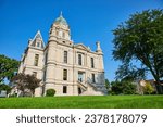 Green lawn and blue sky day with front view of Whitley County Courthouse entrance