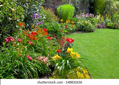 Green lawn in a colorful landscape formal garden. Beautiful Garden.