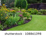 Green lawn in a colorful landscaped formal garden. Beautiful Garden.