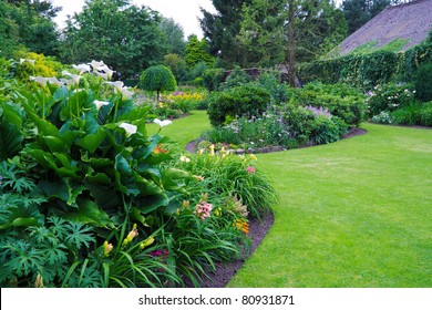 Green lawn in a colorful landscaped formal garden. Beautiful Garden - Shutterstock ID 80931871