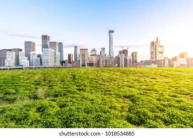 green lawn with panoramic cityscape - Shutterstock ID 1018534885