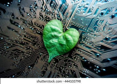 A green leaf with a heart shape on a computer circuit board / green it / green computing / csr / it ethics