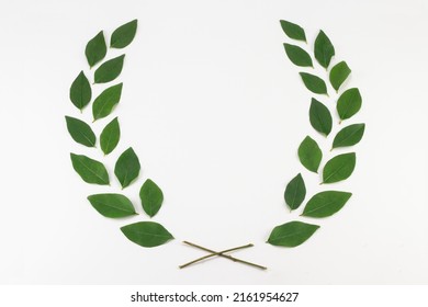 Green leaf wreath on white background. Top view