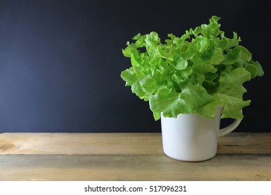 Green Leafy Vegetables In A Cup On The Table.Concept Of Fresh Organic Vegetables.