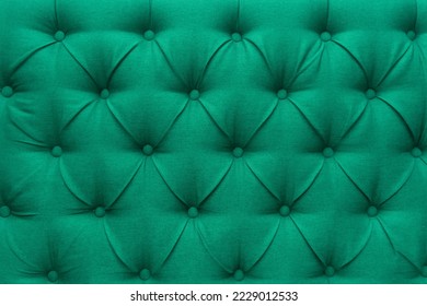 Green leather upholstery sofa pattern button design furniture style decor texture background decoration vintage abstract.