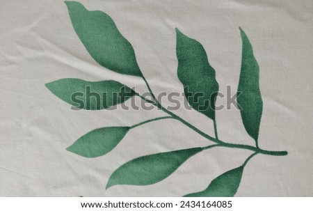 Green leaves on white cloth.  Great for backgrounds, abstracts, leaves, art, batik, fabric, green, beautiful and others.