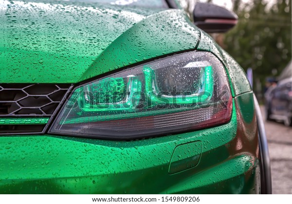 Green led headlights with lens on green modified\
tuned car. Custom car