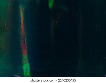 Green Lens Flare. Old Filmstrip Texture. Blur Gleam On Dark Background.