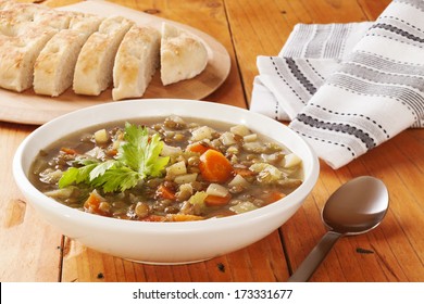 Green Lentil Soup - A Bowl Of Green Lentil Soup With Bread.